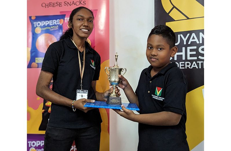 Aquilani Swaminadha collects his award from Jessica Callender of the Guyana Chess Federation