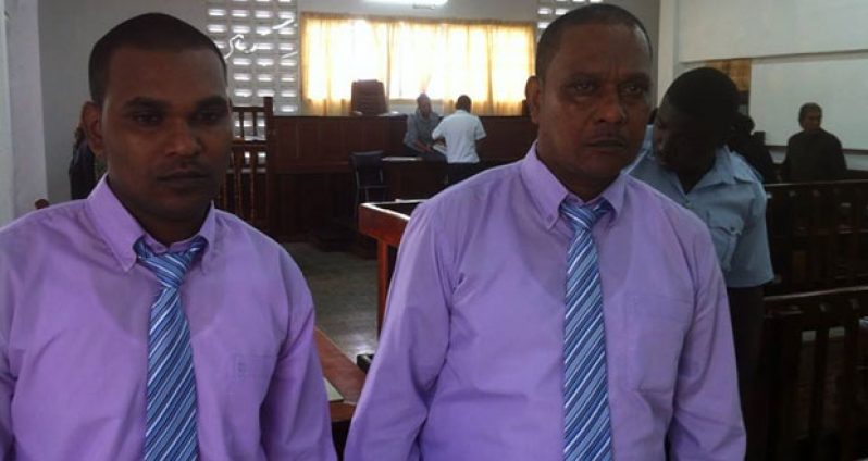 Murder accused ‘John’ Krishna  (right) and his son, Romel Krishna as they prepare to  leave the Berbice Assizes