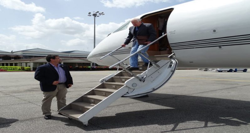 Former U.S. President Jimmy Carter and a member of the U.S. Secret Service, on arrival at the Cheddi Jagan International Airport, Timehri yesterday