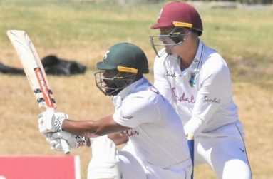 John Campbell sweeps on his way to 129 at the Coolidge Cricket Ground, yesterday.