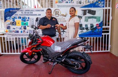 John Ramsingh (left) of FL Sport and Regal Super Centre representative Telesha Ousman-Yamin