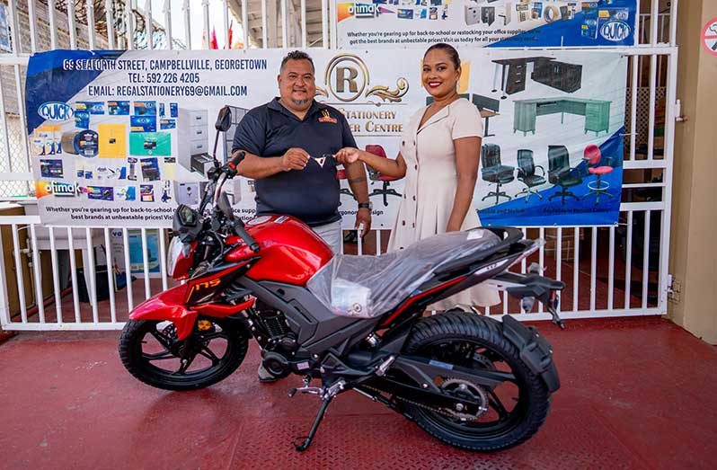 John Ramsingh (left) of FL Sport and Regal Super Centre representative Telesha Ousman-Yamin