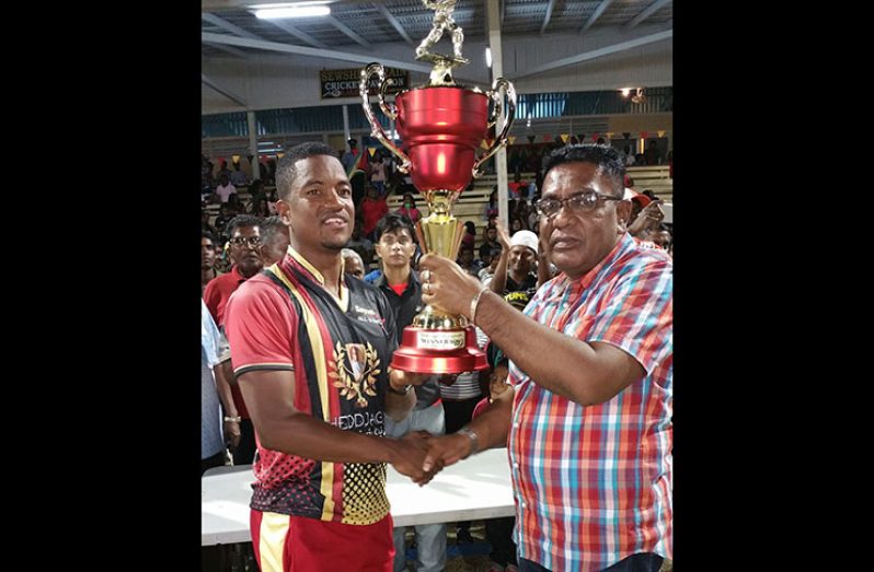 Captain Leon Johnson Collects the winning trophy from Executive member of the People’s Progressive Party, Zulfikar Mustapha