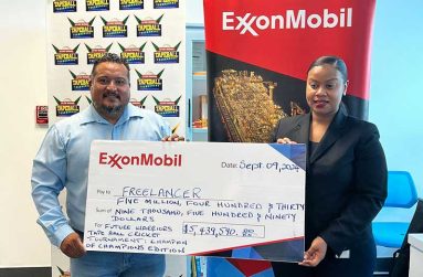 FL Sport’s John Ramsingh (left) collects the ceremonial sponsorship cheque from Community Relations Adviser for ExxonMobil Guyana, Lasawhna Prescott