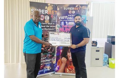 President of the GSCL Inc. Ian John, left, receives the sponsorship cheque from Superbet Operations Manager, Ashvani Kumar Pandey