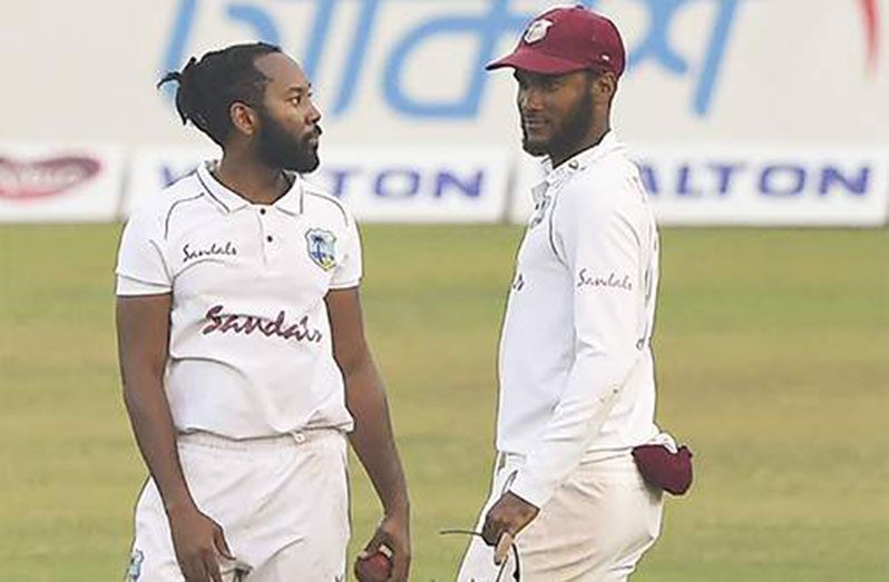West Indies' Captain Kraigg Brathwaite (right) with his teammate Jomel Warrican during the fourth day of the second Test cricket match between West Indies and Bangladesh at the Sher-e-Bangla National Cricket Stadium in Dhaka yesterday. (Photo: AFP)