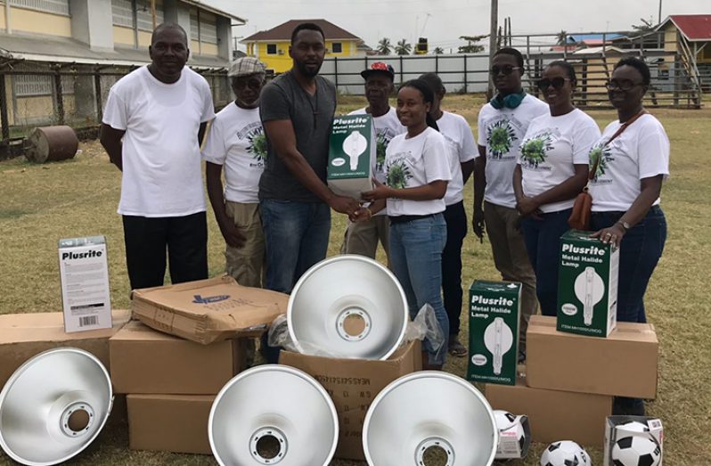 Director of Sport Christopher Jones hands over the first batch of lights to representatives of the BV/Triumph area.