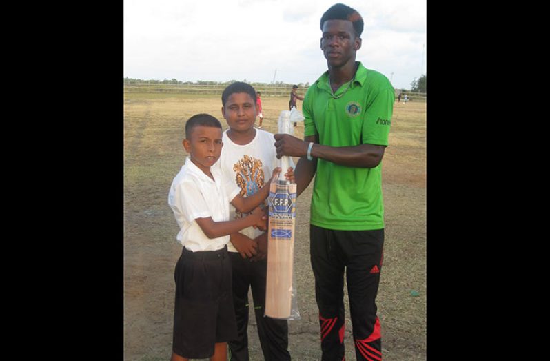 RHTY&SC member Sylus Tyndall (right) hands over the cricket bat to Jason Jones in presence of RHTY&SC assistant secretary Simon Naidu.