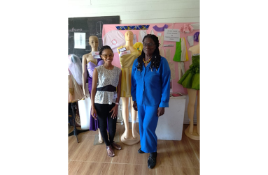 Creative Fashion Designer, Joy Washington flanked by one of her many students of Burrowes School of Arts
