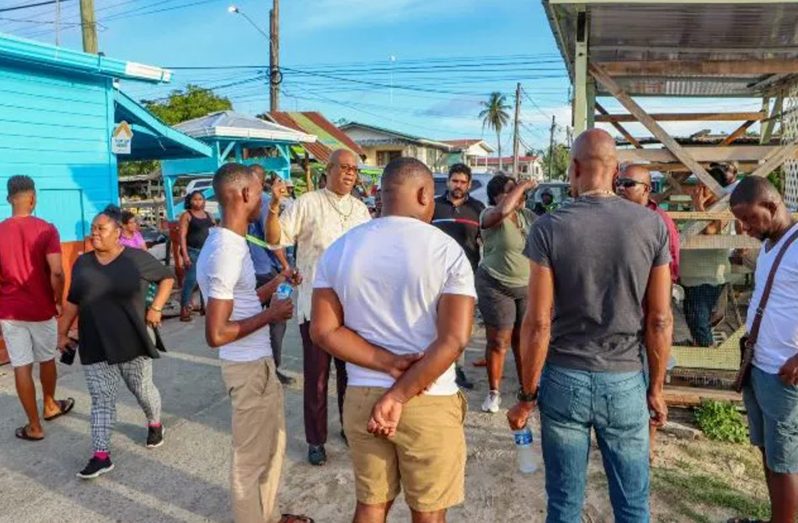 Minister of Public Works, Juan Edghill, interacting with residents and vendors of Plaisance