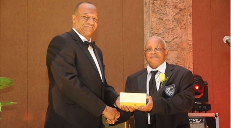 Minister of State, Joseph Harmon with one of the awardees at the Jubilee celebration