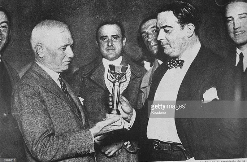 Jules Rimet, president of FIFA (Federation Internationale de Football), presents the first World Cup trophy (the Jules Rimet Trophy) to Dr Paul Jude, the president of the Uruguayan Football Association.