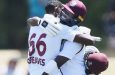 Justin Greaves (left) and Kemar Roach embrace after Greaves scored a match-saving double century against New Zealand