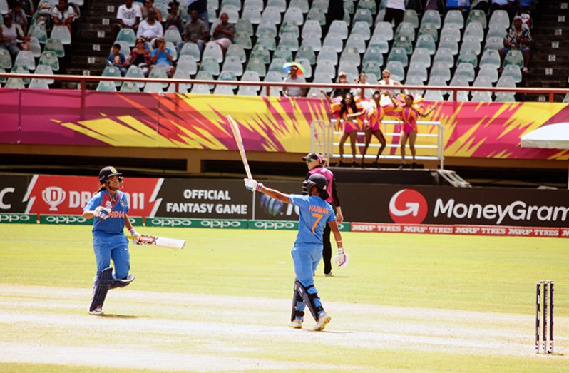 India captain Harmanpreet Kaur (right) celebrates on reaching her maiden T20 International century with Jemimah Rodrigues. (Adrian Narine photo)