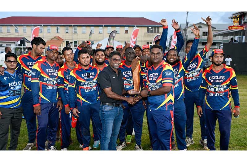 The victorious Eccles All-Stars, the East Bank Demerara/West Demerara zone champions in the Kares One Guyana T10 Tapeball Blast 2025, as KFC Guyana's Chief Executive Officer, Paul Subryan, hands over the KFC first prize