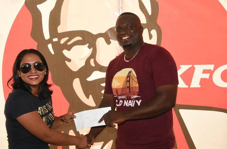 KFC King’ Jarrel Leander collects his voucher from Marketing Manager Livasti Bhooplall