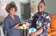 Victoria Kings Treasurer Ms Maleasa Solomon (right) receiving one of the footballs from Ms Rondia Lancaster Office Manager of Devcon Construction and Industrial Supplies and Services.
