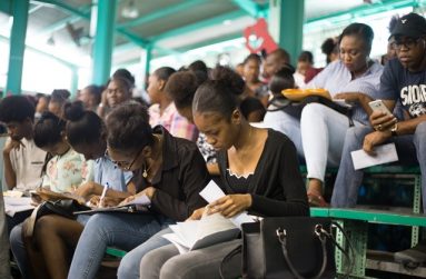 Young people work on applications during the employment drive, hosted by the Department of Social Cohesion. (Photo courtesy of the Department of Public Information)
