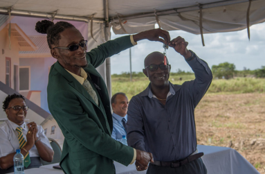 Mr. Phillip Chase receives the keys to his new home. (Courtesy of the Department of Public Information)