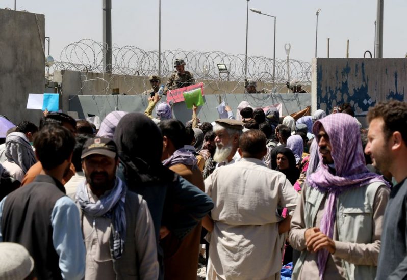 Crowds of people show their documents to U.S. troops outside the airport in Kabul, Afghanistan August 26, 2021 (REUTERS/Stringer)