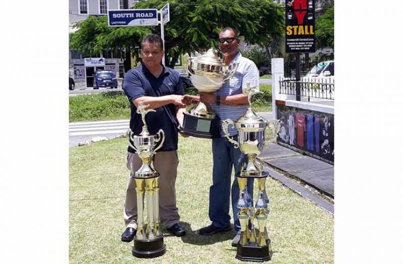Ramesh Sunich and Frank Woon-A-Tai display the championship trophies.