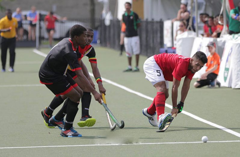 Guyana’s Kareem McKenzie (left) is seen with other players during a match against Mexico at the Pan American Junior Hockey Championships last year.