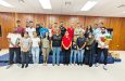 President Vidushi Persaud-McKinnon, in red, in middle and, on her right in black, Dr. Karen Pilgrim, flanked by participants).