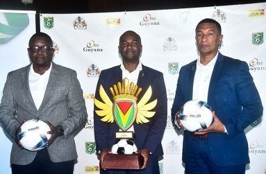 From left, GFF Technical Director (ag) Bryan Joseph, GFF president Wayne Forde and NSC chairman Kashif Muhammad take a photo-op during the draw yesterday. (Adrian Narine photo)