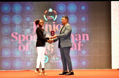 Junior Sportswoman of the Year, Attoya Harvey (left) receiving her award from Chairman of the National Sports Commission (NSC) Kashif Mohammad,  on Sunday night.( Adrian Narine photo)