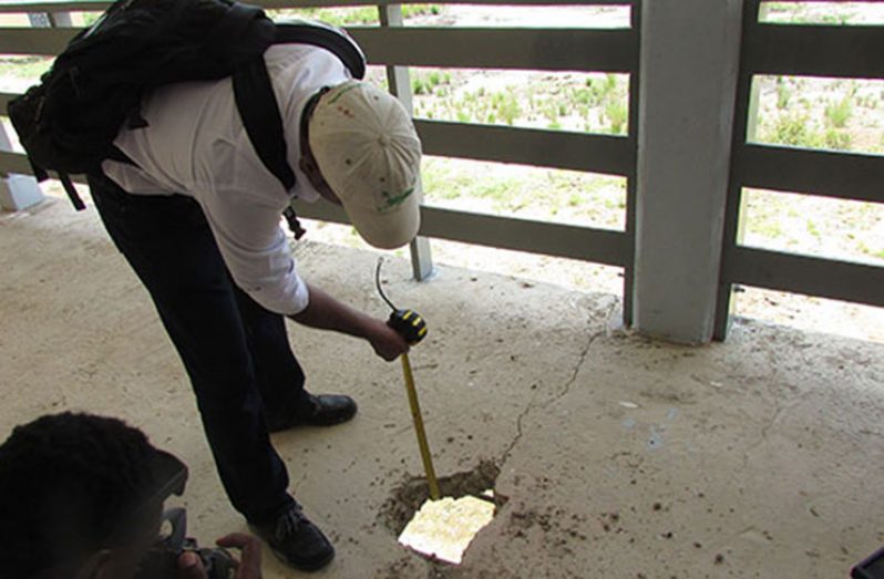 Architect Davendra Doodnauth of Rodrigues Architects Ltd. points out a structural defect during a tour of the Kato Secondary School construction project. It is estimated that it will cost $140 million to fix the defects