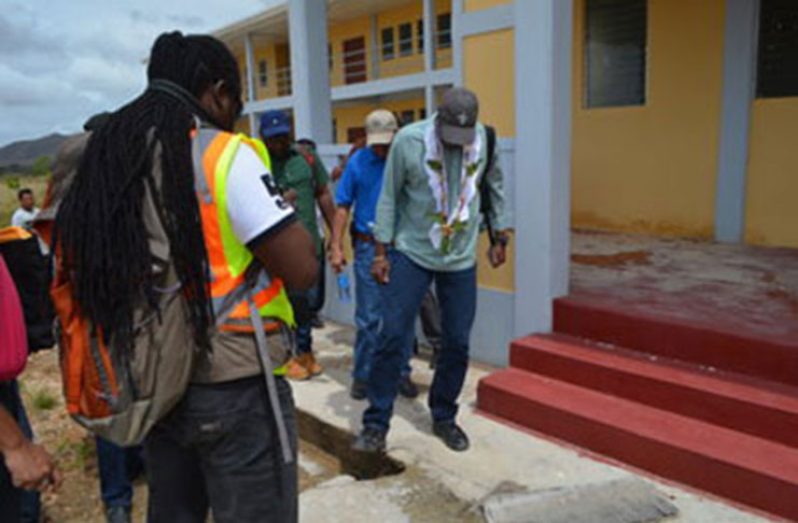 In February, Minister of Education, Dr. Rupert Roopnaraine, taking a look at the hole in the floor in one of the buildings of the Kato Secondary School complex, Region Eight