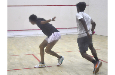 Kaylee Lowe (left) play a backhand shot in her 3-1 win over Justin Goberdhan (Sean Devers photos)