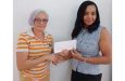 Aysha Khan, director of K Corp (right) hands over the cheque to GMR&SC Office Executive Cheryl Gonzalves
