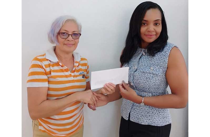 Aysha Khan, director of K Corp (right) hands over the cheque to GMR&SC Office Executive Cheryl Gonzalves