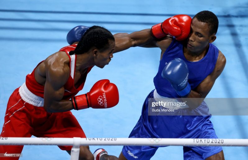 TOKYO, JAPAN - JULY 24: Keevin Allicock (L) of Guyana exchanges punches with Alex Miguel de la Cruz Baez of Dominican Republic during the Men's Feather (52-57kg) on day one of the Tokyo 2020 Olympic Games at Kokugikan Arena on July 24, 2021 in Tokyo, Japan. (Photo by Buda Mendes/Getty Images)