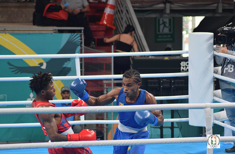 Keevin Allicock (blue) battling for Guyana at the Pan American Games in Chile (Photo: Guyana Olympic Association/Akeem Greene)