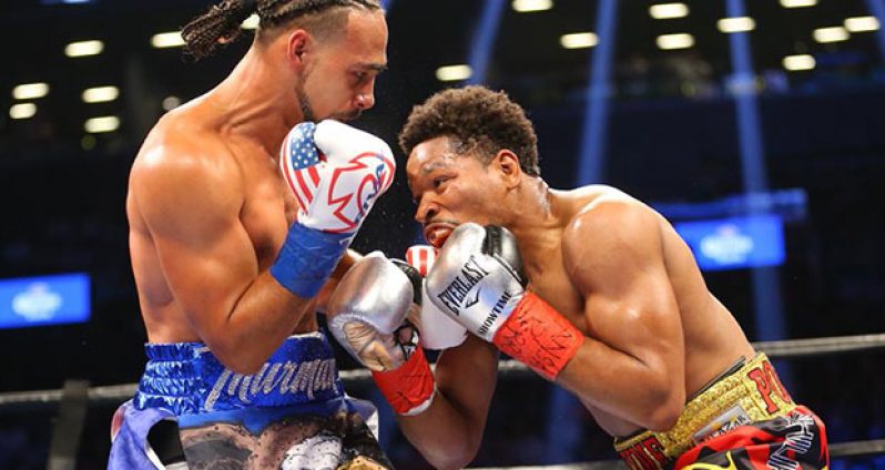 Keith Thurman (left) was greeted by boos after defending his WBA welterweight title against Shawn Porter..