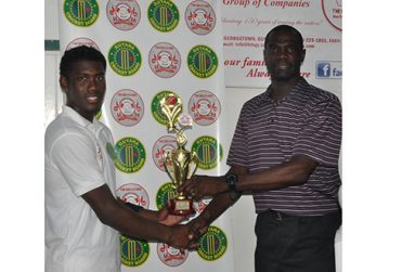 Keemo Paul collects his man-of-the-match award from Match Referee Reon King