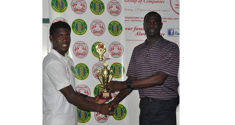 Keemo Paul collects his man-of-the-match award from Match Referee Reon King