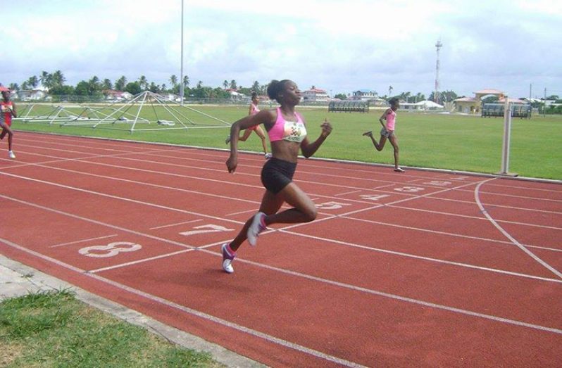 Kenisha Phillips winning the girls' 15 - 17 100m dash