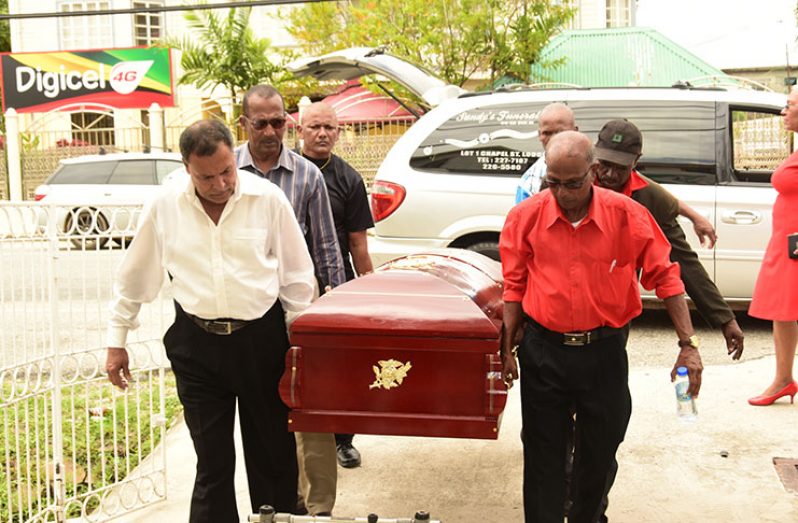The pallbearers carrying the casket of the late Kenneth Joseph at NAACIE for viewing on Saturday