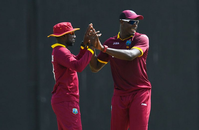 Kesrick Williams (left) celebrates with Carlos Brathwaite during Sunday’s seven-wicket defeat to Pakistan at Queen’s Park Oval. (Photo courtesy WICB Media)