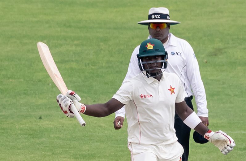 Kevin Kasuza celebrates his fifty on debut © AFP