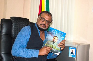Roshan Khan with a copy of his new book, “My Words, My Vision, My Thoughts”