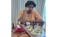 National Chess champion, Taffin Khan, over a board