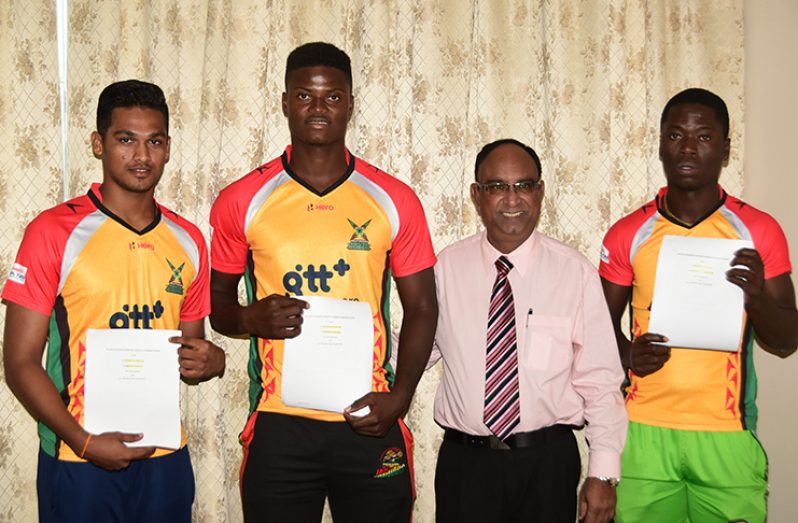 The Guyana Amazon Warriors Team Operations Manager, Omar Khan, with the three local newcomers