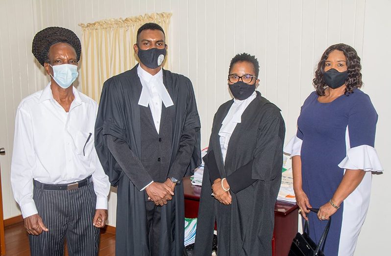 Khawn Rodney (second left) with his parents, Hector and Maple Rodney, and Justice Fidela Corbin-Lincoln (second right) after being admitted to the bar