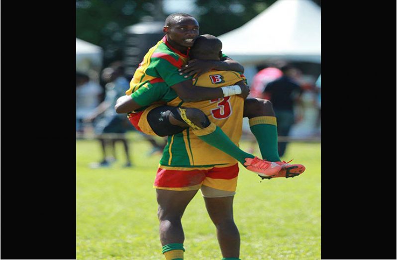 Patrick King celebrates in the arms of Dwayne Schroder (#3) after helping Guyana win  Rugby America's North (RAN) 7's Championship for a record eight times last year.