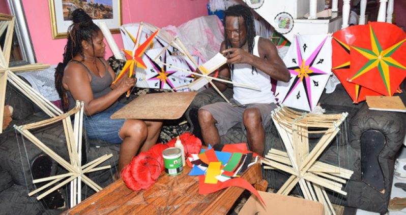 A family making kites for sale, Saturday. (Cullen Bess-Nelson photo)