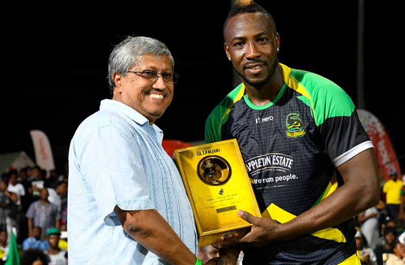 Andre Russell (right) of the Jamaica Tallawahs receives an El Dorado commemorative bottle of rum from Demerara Distillers Limited (DDL) Chairman Mr. Komal Samaroo (left) at the end of the Hero Caribbean Premier League 2016  (CPL) Final at Warner Park in Basseterre, St Kitts. Credit: CPL/Sportsfile